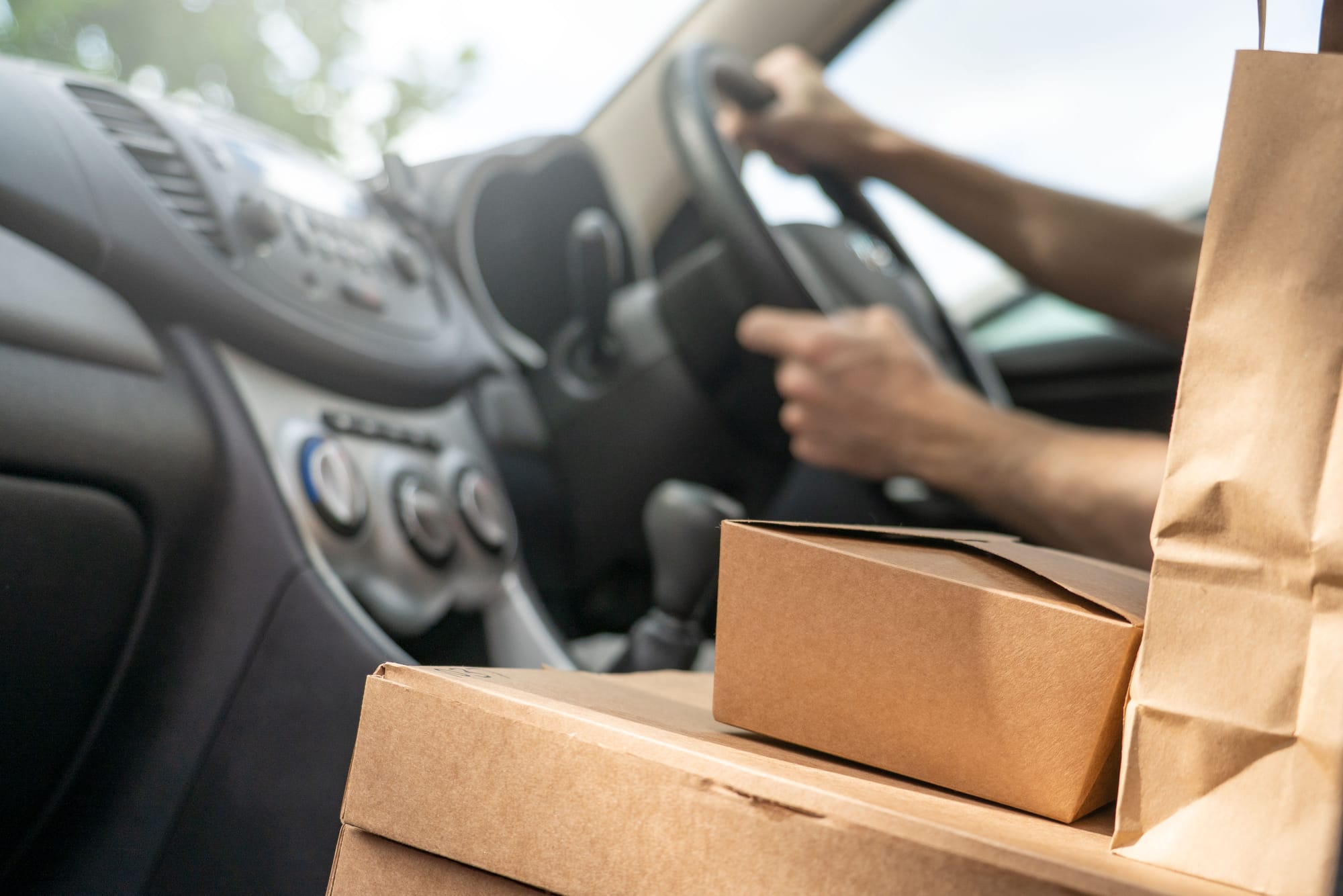 Fulfillment and shipping verification A delivery driver with packaged orders in a vehicle, representing the fulfillment and shipping data a checkout session verifies before a sale completes